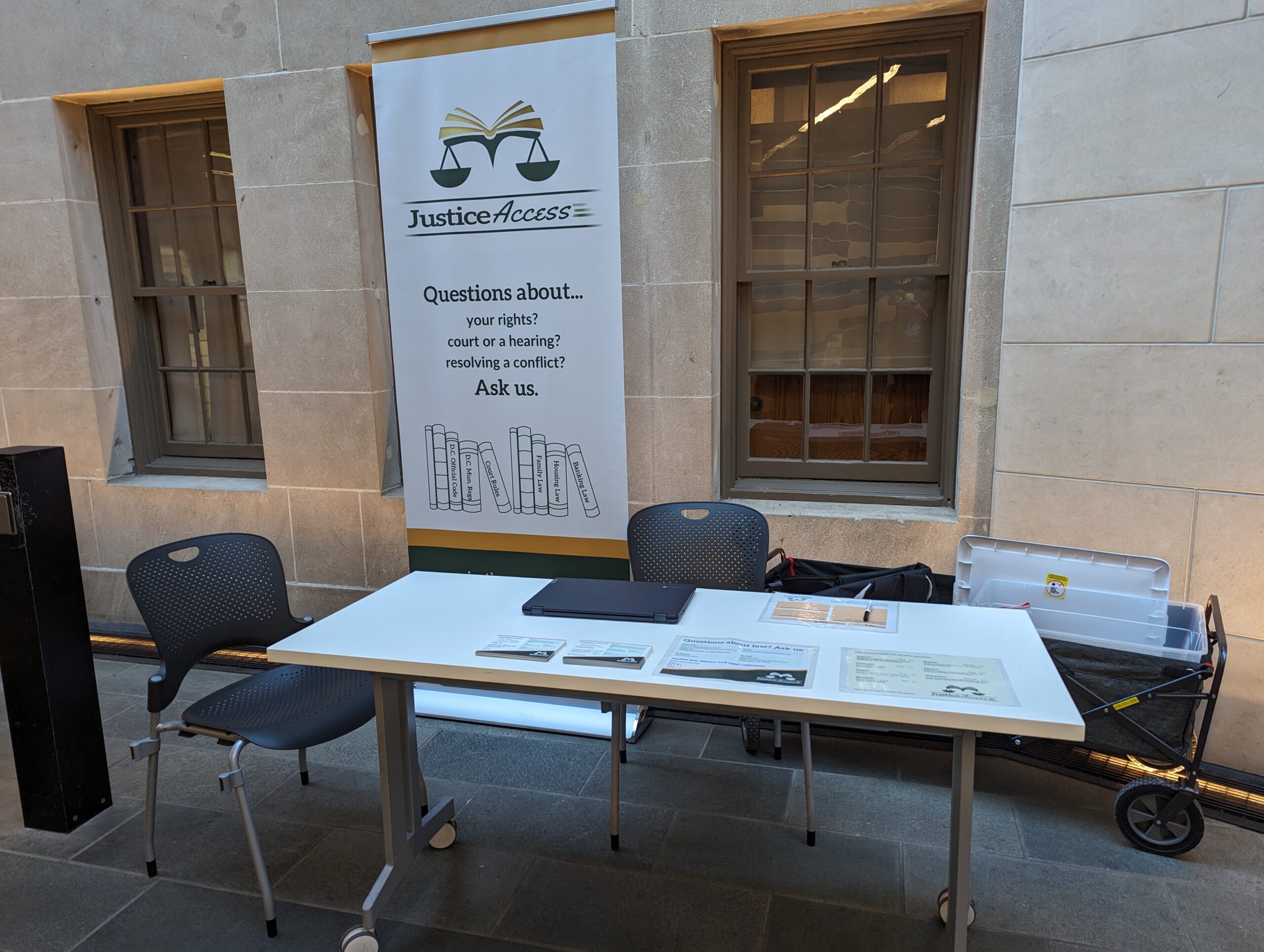 our set-up at Mt Please library showing a stand-up banner and a table with flyers on it